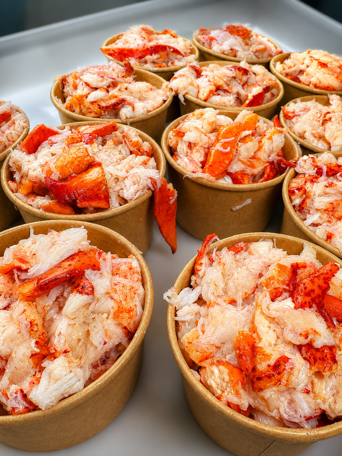 Portioned lobster meat in cups ready for service