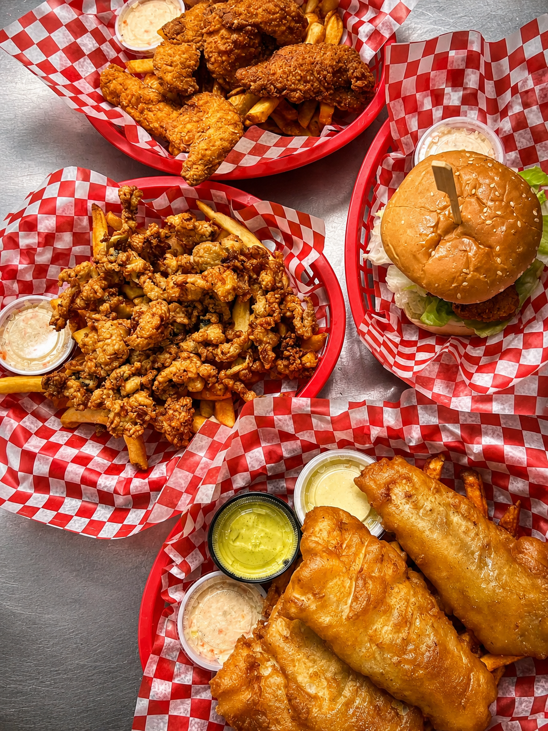 A sharing spread with a fish burger, fried seafood and sides