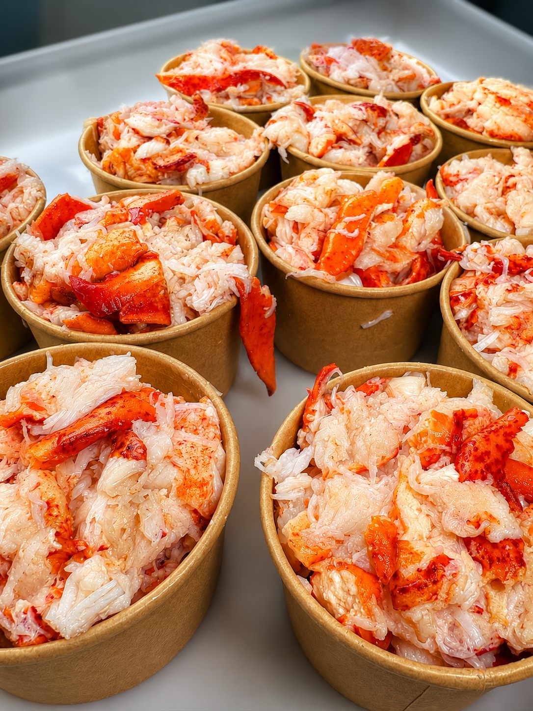 Portioned lobster meat in cups ready for service